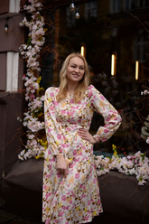 a lady in a floral printed pink dress